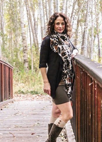 Our team member, Dr. Stacey Gividen standing in front of a wooden bridge